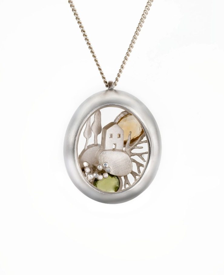 Miniature scenes encapsulated in gold and silver pendants