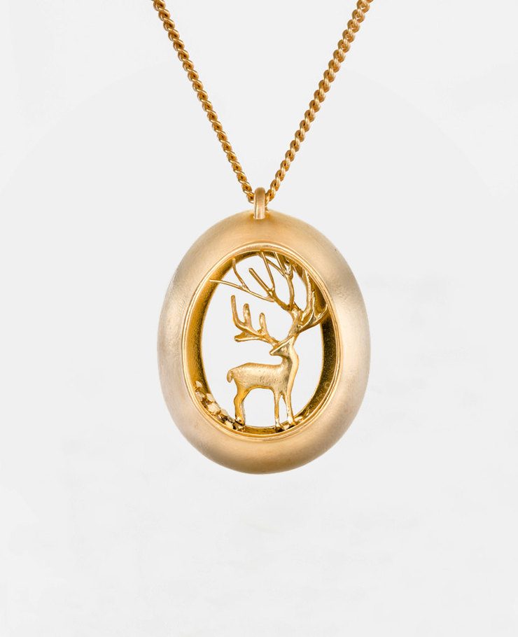 Miniature scenes encapsulated in gold and silver pendants