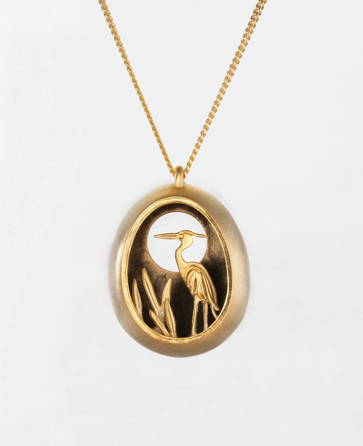 Miniature scenes encapsulated in gold and silver pendants