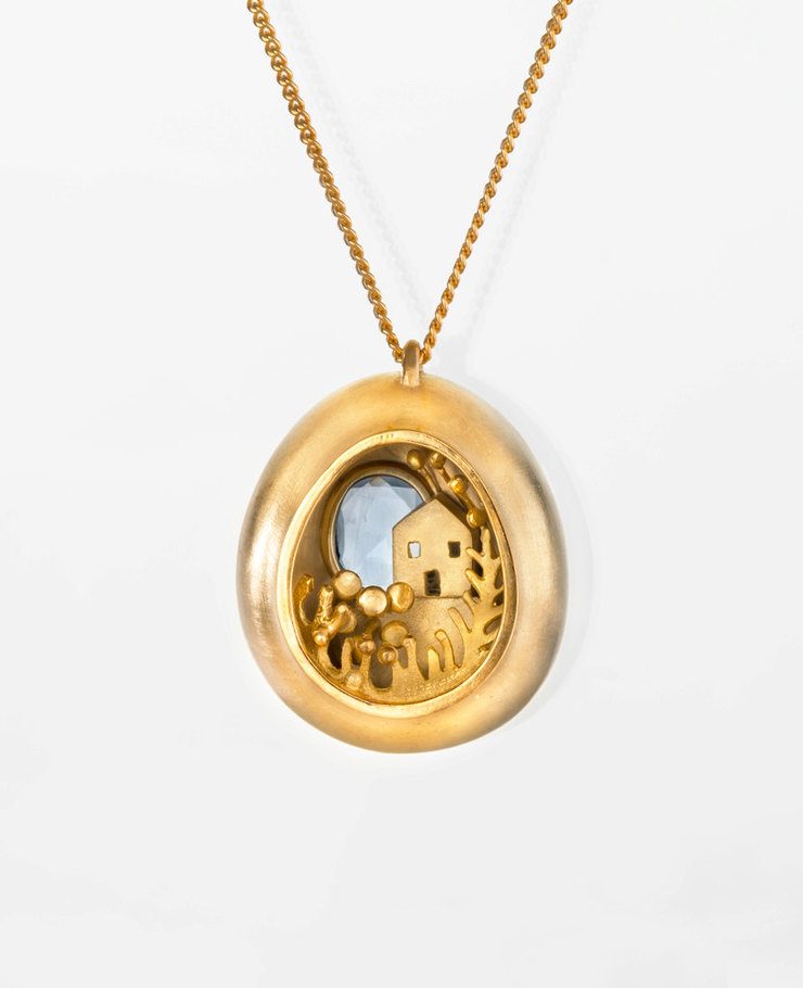 Miniature scenes encapsulated in gold and silver pendants