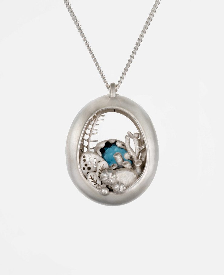 Miniature scenes encapsulated in gold and silver pendants